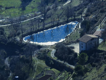 High angle view of trees and buildings in city