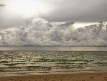 View of calm sea against cloudy sky