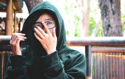 Portrait of young woman wearing hooded shirt