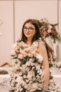 Portrait of woman with pink flower