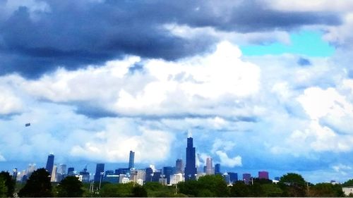 City skyline against cloudy sky