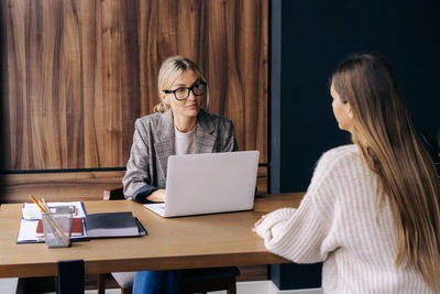 Woman professional hr interviews a candidate for a vacancy  in the office at the workplace.