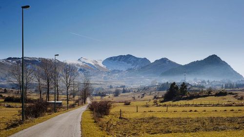 Empty road leading towards mountains