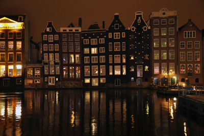 Reflection of illuminated buildings in water at night