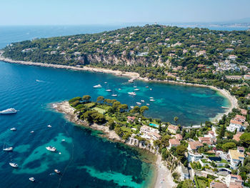 High angle view of sea and cityscape against sky