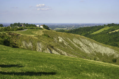 Scenic view of landscape and sea against sky