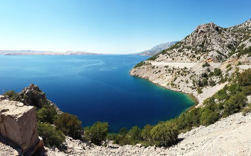 Scenic view of lake against clear blue sky