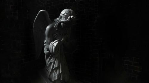 View of angel statue in darkroom