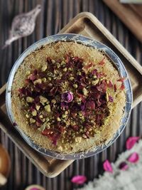 Oriental nice kunafa sweets isolated on wooden board with blurred background.