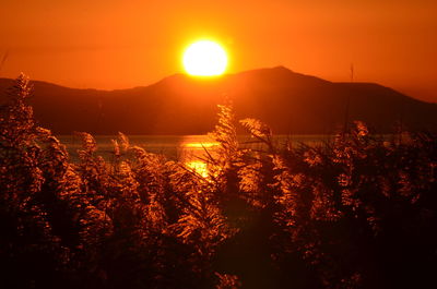 Scenic view of silhouette mountains against sky during sunset