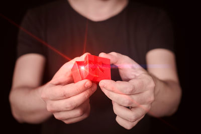 Close-up of man holding red light