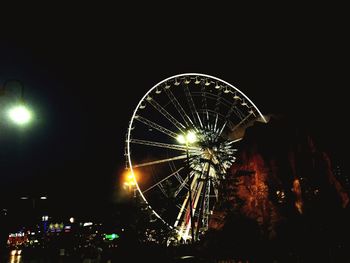 Low angle view of illuminated ferris wheel