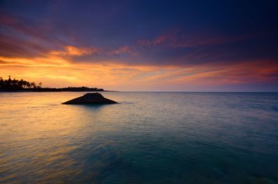 Scenic view of sea against sky at sunset