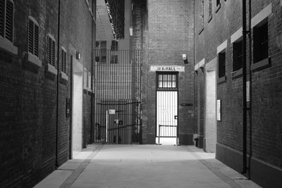 Empty alley amidst buildings in city