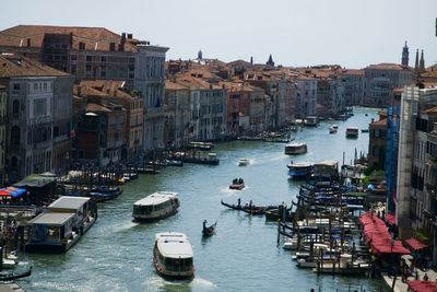 High angle view of boats in canal amidst buildings in city