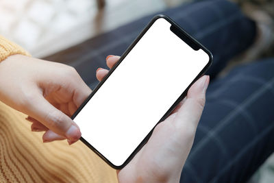 Close-up of hand holding mobile phone