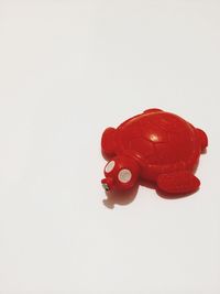 Close-up of red object over white background