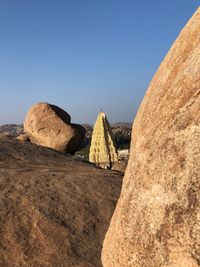 Panoramic view of rock formations against clear blue sky