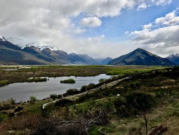 Scenic view of lake and mountains against sky