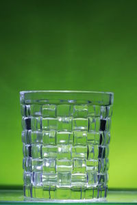 Close-up of wine glass against green background