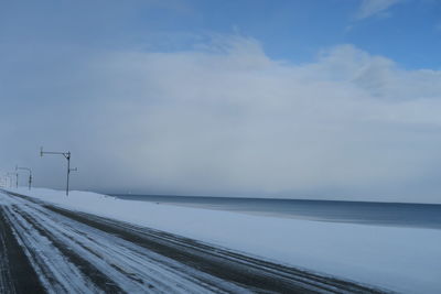 Scenic view of snow covered landscape against sky