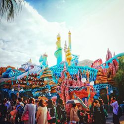 Low angle view of carousel against sky