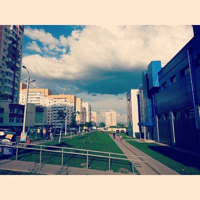 building exterior, architecture, built structure, sky, city, cloud - sky, transportation, transfer print, cloudy, auto post production filter, cloud, cityscape, building, city life, road, street, incidental people, land vehicle, residential building, office building