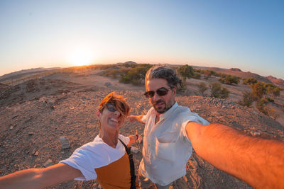Portrait of smiling couple during sunset
