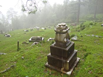 View of cemetery on field during foggy weather