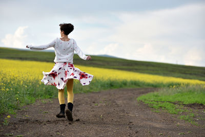 Full length of woman standing on field