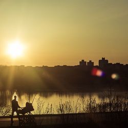 Scenic view of river at sunset