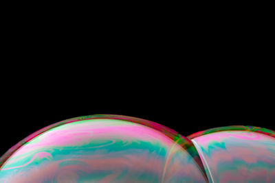 Close-up of bubbles over black background