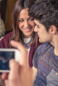 Portrait of smiling young woman using mobile phone