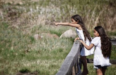 Side view of girl standing on field