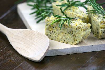 Close-up of baked food on wooden cutting board