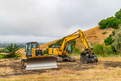 Construction machinery. bulldozer and excavator are clearing construction site.