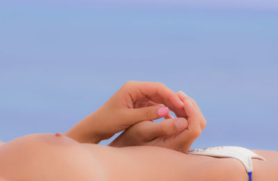 Cropped image of sensual woman against sky