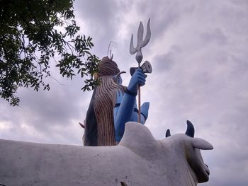 Low angle view of statue against sky