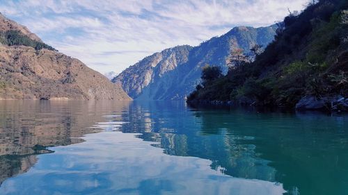 Scenic view of lake and mountains against sky