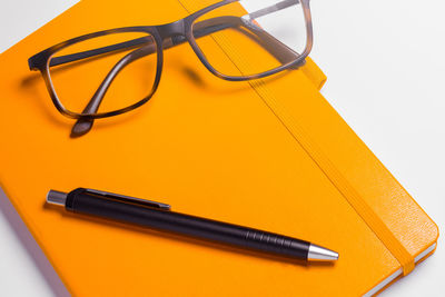 High angle view of pen on table against white background
