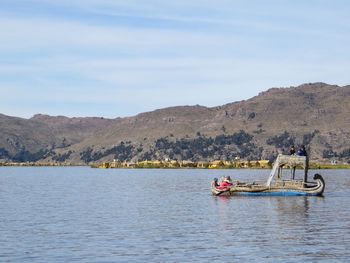 Man in boat on sea against sky