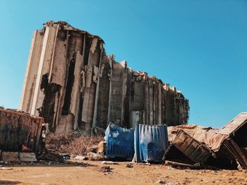 Damaged building against clear blue sky