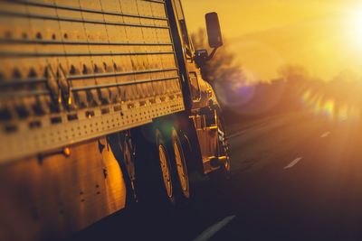 Close-up of truck on road during sunset