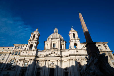 Low angle view of historic building against clear blue sky