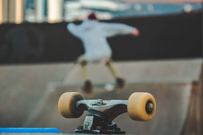 Skateboard wheels with man performing stunt in background
