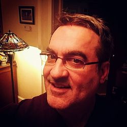 Portrait of man wearing eyeglasses at home