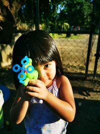 Portrait of cute girl holding camera