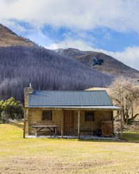 Built structure on field against sky