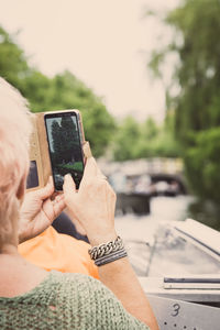 Midsection of man using mobile phone