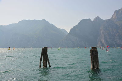 Scenic view of sea and mountains against clear sky